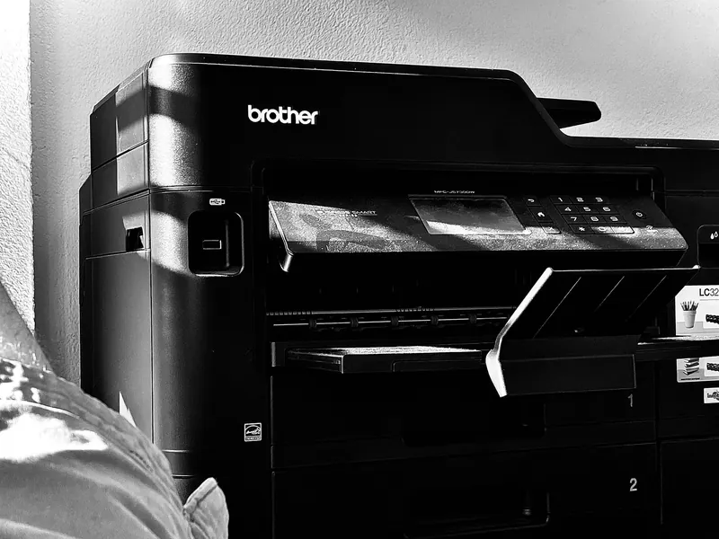 A Brother multifunction printer with its output tray extended