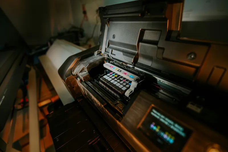 A printer opened up to show its colour cartridge bay