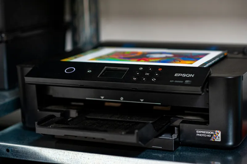 A colour photograph emerging from an Epson inkjet printer