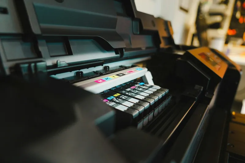 Close-up of colour ink cartridges seated in a printer carriage